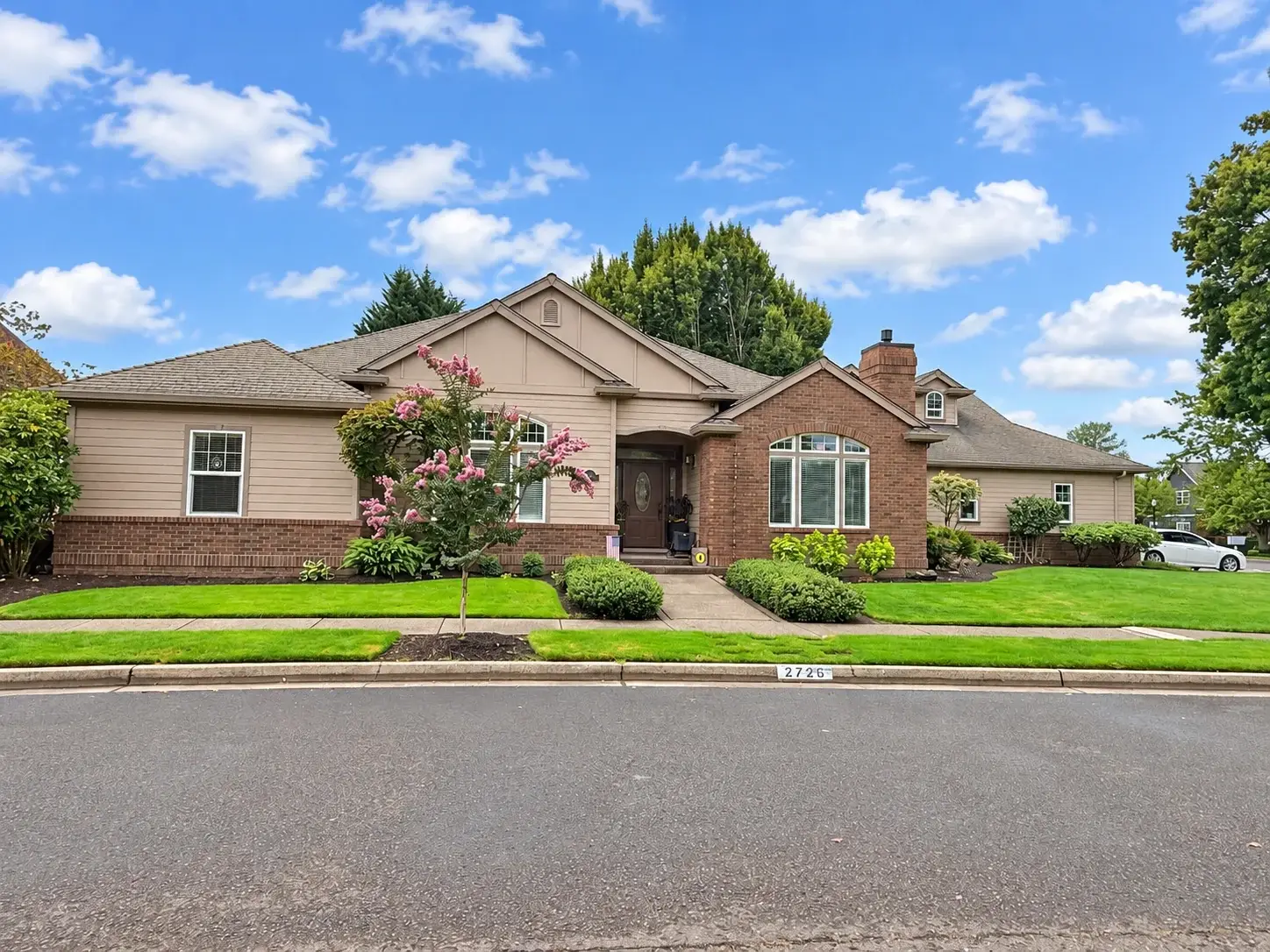 Single-level home with brick accents, a brick chimney, and a recessed entry